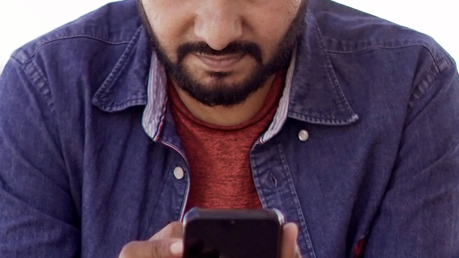 Man reading an app notification on his smartphone