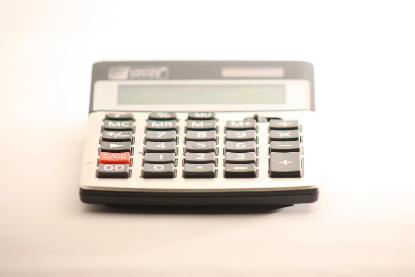 Silver desktop calculator on a plain white surface