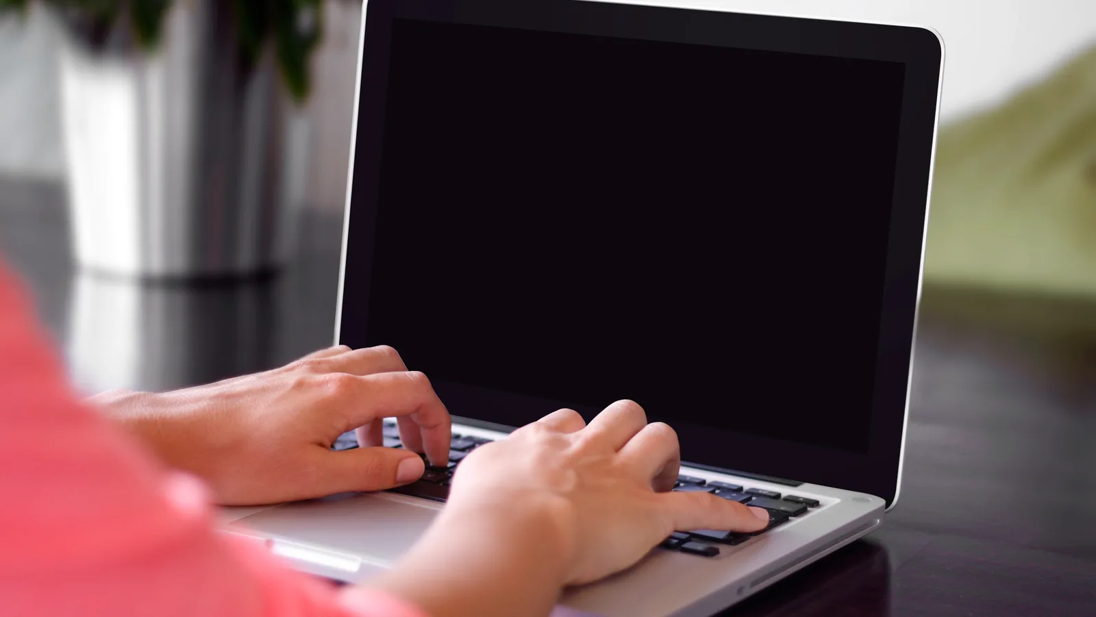 Marketer typing an email campaign on a laptop